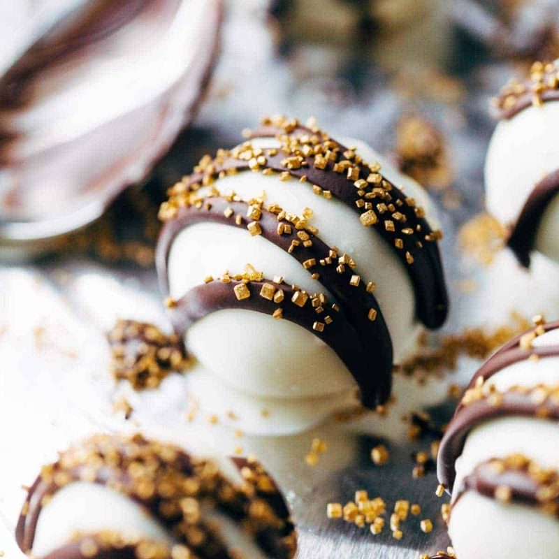 Desserts of white balls with chocolate stripes.