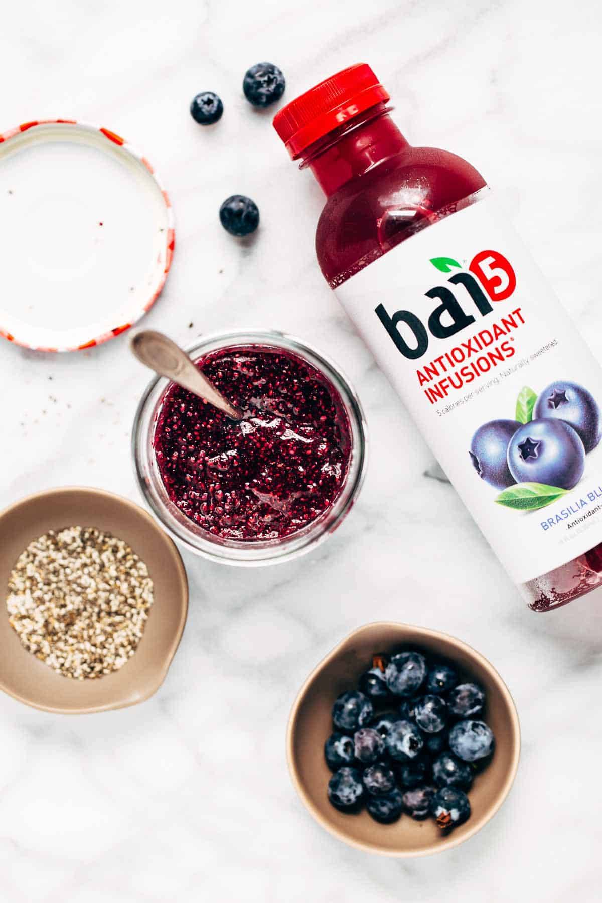 Jars with blueberries, jam, and seeds with Bai5 juice.