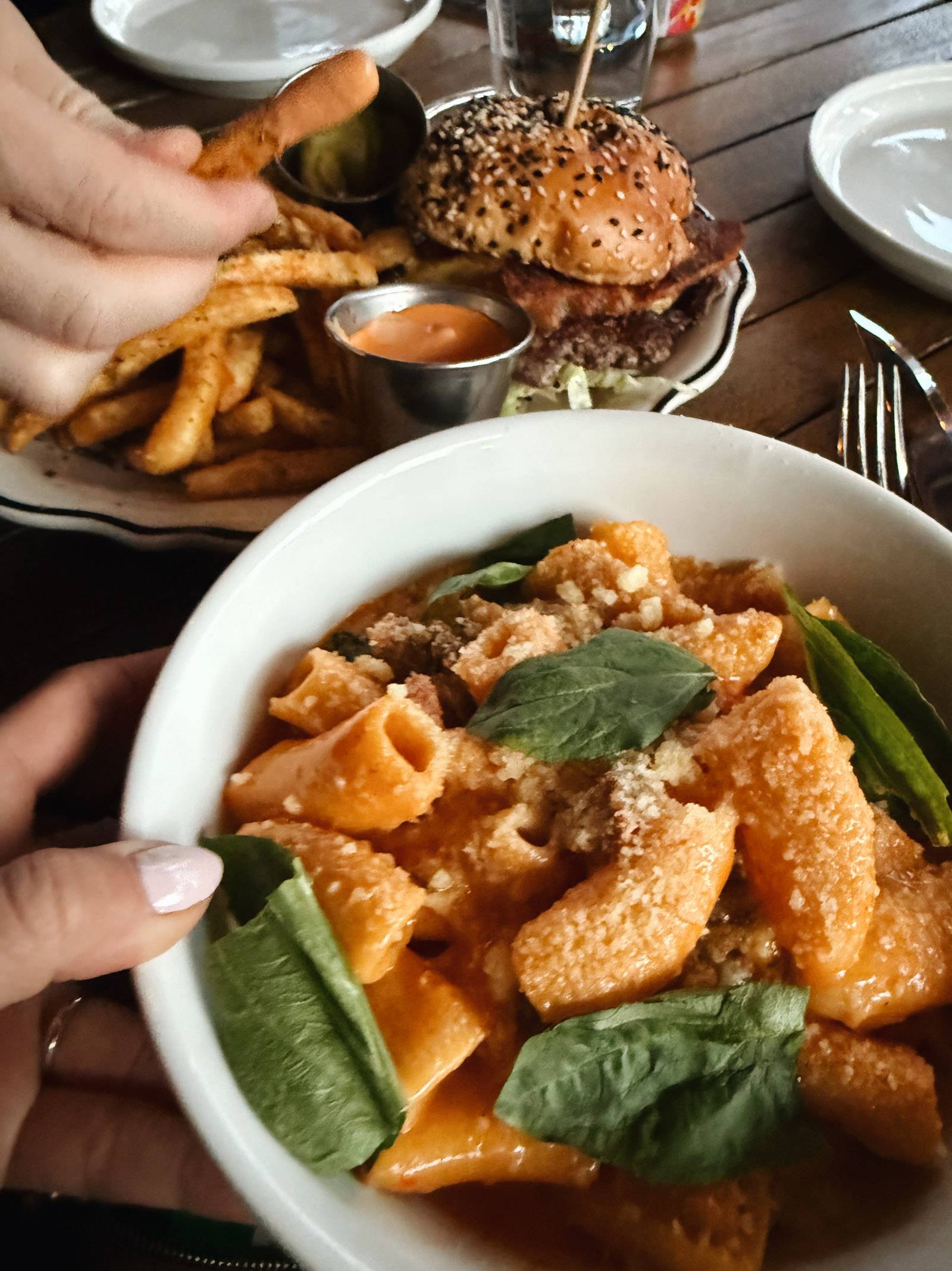 Bowl of rigatoni with basil on top.