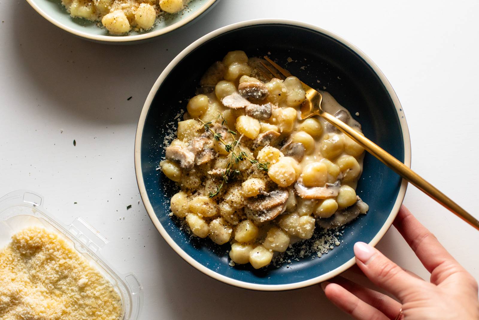 Mushroom gnocchi in a bowl with a fork.
