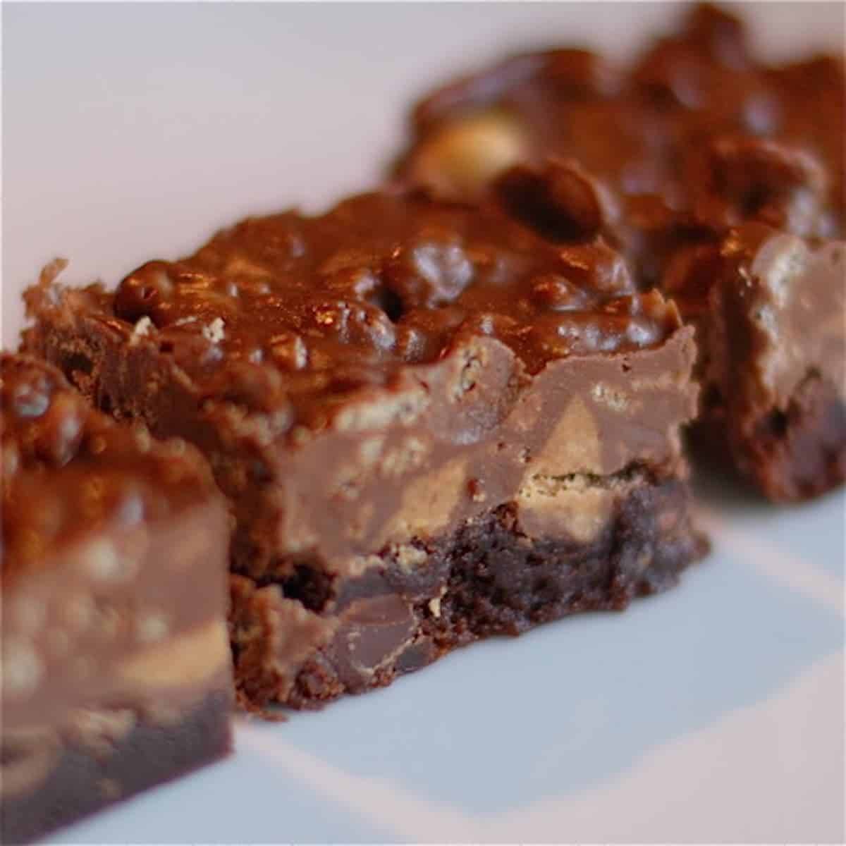 Three scotchabrownies on a white surface.